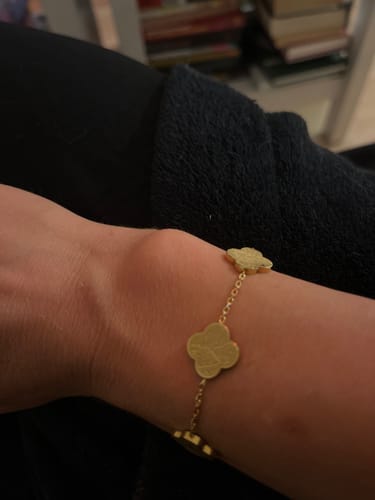 Close-up of a customer's wrist wearing the gold Sabr, Shukr, Tawakkul bracelet.