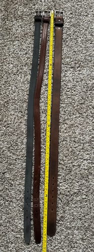 Customer's photo comparing the longer Montana Bison Double Layer belt to two other belts to show the difference in sizing.