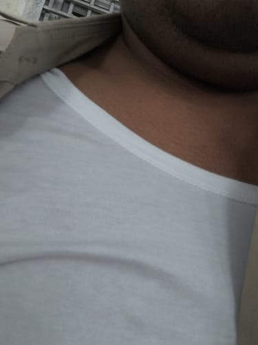 Close-up of a reviewer wearing the white Kings RNS cotton vest.