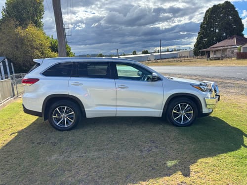 Reviewer's shiny white 4WD parked on a lawn after being cleaned with Salt Exterminator wash.