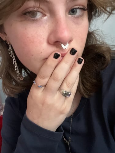 Close-up of a reviewer wearing the silver BUTTERFLY SEPTUM piercing.