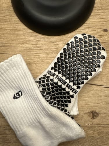 Customer's close-up of the white Reformer Sock, showing the extensive black silicone grip pattern on the sole.