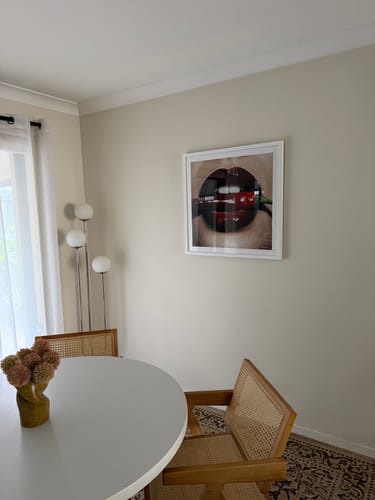 Reviewer's Hot Ones | Art Print in a white frame hung on a wall in a contemporary dining room.