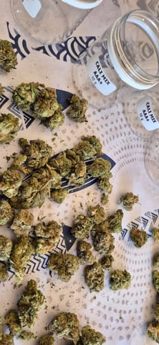 Customer's CALI MIX AAA+ buds spilled from two labeled jars, appearing dry and broken up.