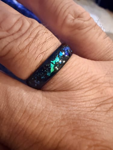 Customer's close-up of the Zarion ring on their finger, showing the glowing blue-green opal inlay.