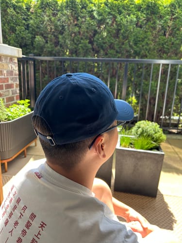 Close-up of the back of the reviewer's Big Dad Hat Washed, showing the adjustable strap.