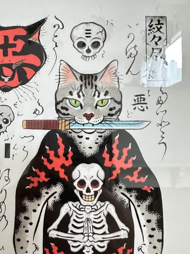 Close-up of a customer's Samurai Flash Print showing a tattooed cat holding a sword in its mouth.