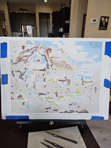 Customer's 'Cottage Seaview' paint-by-numbers canvas, shown partially painted on an easel.