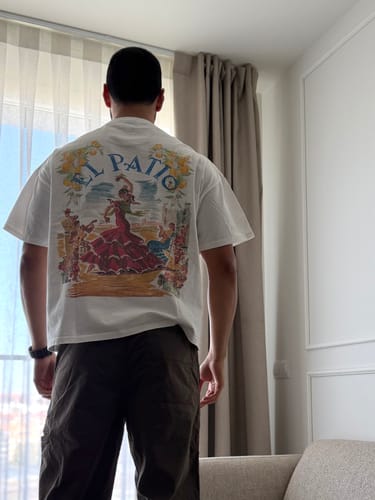 Customer wearing the LA CAMISETA: FLAMENCA t-shirt, seen from the back to show the detailed flamenco graphic.