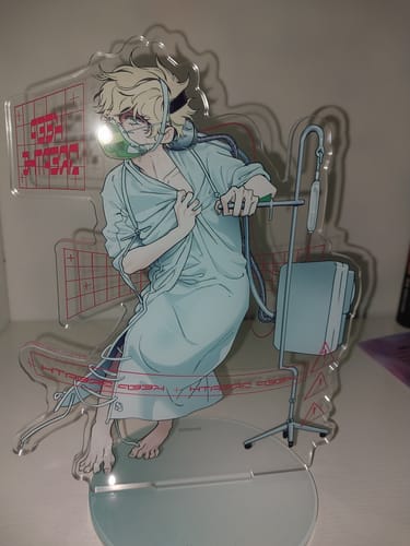 Customer's Alien Stage Anakt Garden Collection acrylic stand showing the character in a hospital gown and oxygen mask.