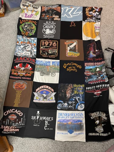 Reviewer's finished Project Repat T-Shirt Quilt, made as a memory blanket from various motorcycle and graphic t-shirts.