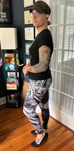 Reviewer standing in a room, showing a side view of the black-and-white patterned Death - Scream Bloody Gore leggings.