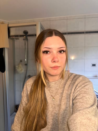 Kundin zeigt ihre langen Wimpernextensions, die sie mit dem DUO PEN BOND & SEAL aufgetragen hat.