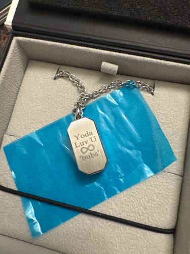 Customer's engraved Beveled Edge Urn Pendant shown in its box. The inscription reads, "Yoda Luv U ∞ 'bubs'".