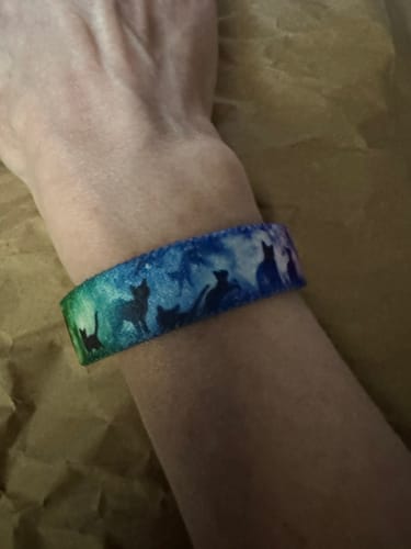 Customer wearing the Until We Meet Again Cat Bracelet, showing cat silhouettes against a blue and green design.
