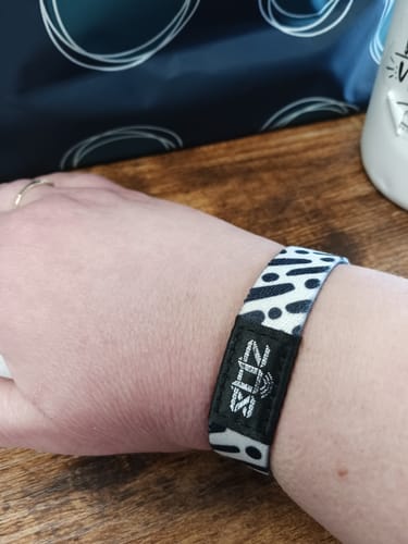 Customer's close-up of the black and white patterned "I Am With You, Always" Bible Verse Bracelet worn on their wrist.