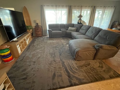Customer's large charcoal Mellow Mat Cloud Haven 3D rug placed in a living room.