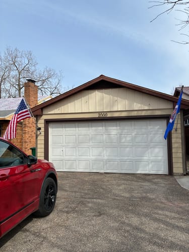 Customer's Heavy Duty American Nylon Flag displayed on the front of a house next to a garage.