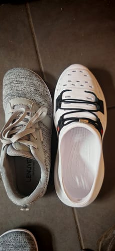 Reviewer's white Wildpool shoe placed next to a grey sneaker for a size comparison.