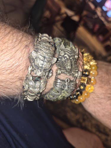 Customer's wrist wearing multiple bracelets, including one with the cupronickel ANUBIS clasp.