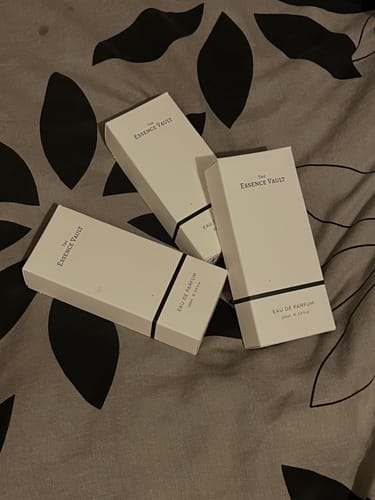 Customer's three white boxes for 'Inspired by Baracatt Rouge 540 - 461' perfume on a patterned surface.