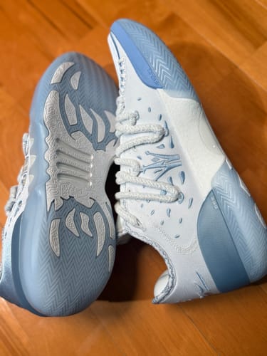 Reviewer's white and light blue Joker 2 'Denver' basketball shoes, showing the shoe's side profile and Diamond Grip outsole.