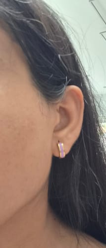 Close-up of a reviewer wearing the purple and gold Enamel Stripe Earring.