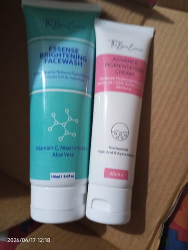 Reviewer's Advance Lip Pigmentation Cream in a white and pink tube, shown next to another skincare item.