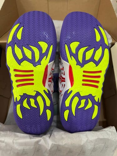 Customer's Joker 2 "Wildcard" shoes, showing the purple herringbone traction and lime-green details on the bottom soles.