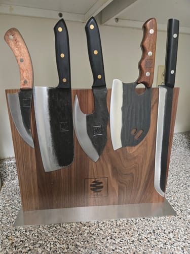 Customer's set of five assorted Mystery Knives displayed on a wooden magnetic block.