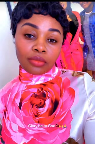 Reviewer in a close-up showing the mock neck and pink floral print of the maxi dress.