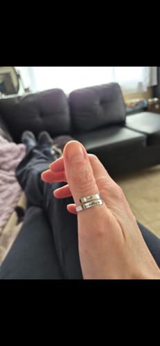 Close-up of a customer's hand wearing the engraved Just Breathe Ring on their thumb.