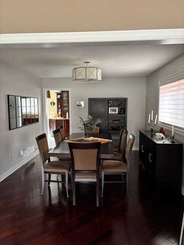 Customer's Modern Black Grid Wall Mirror hung horizontally on a light gray wall in a dining room.