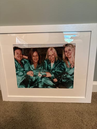 Reviewer's completed Custom Diamond Painting of four friends in matching robes, displayed in a white frame.