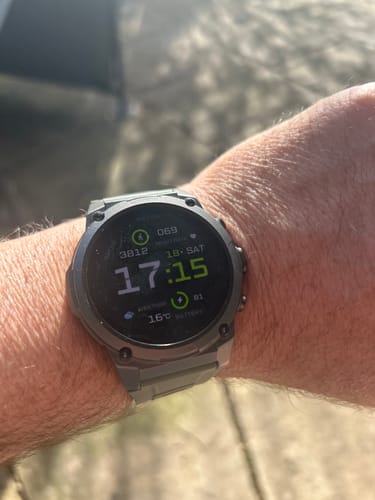 Customer wearing the rugged, grey Gard Pro Ultra 3 smartwatch on their wrist outdoors.