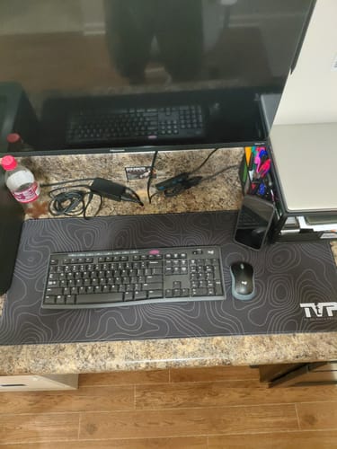 Reviewer's Premium Topo Desk Pad on a desk with a full-size keyboard and mouse, highlighting its large surface area.