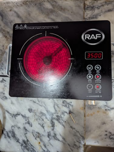 Customer's black RAF Infrared Electric Stove turned on, with the heating element glowing red and the display showing 3500.