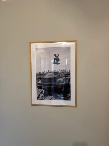 Customer's black and white photo framed with a White Gallery Mat Board and hung on a wall.