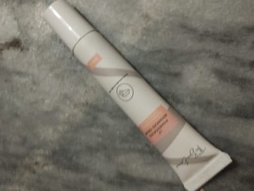 Customer's tube of Advance Lip Pigmentation Cream on a grey marbled surface.