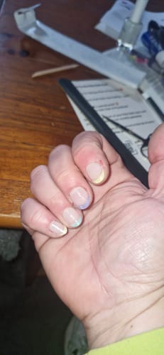 Customer's hand showing nails with pastel French tips, created with the Holy Gels Starter Kit.