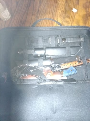 Partial view of a customer's Mystery Knife Pack showing assorted knives inside a black carrying case.