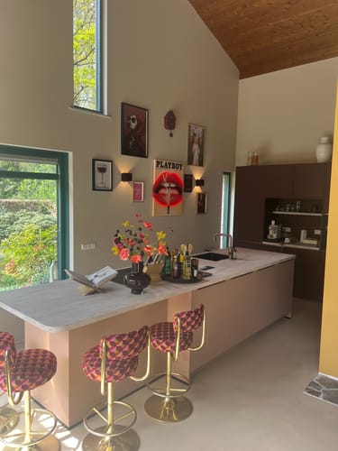 Customer's gallery wall with multiple art prints, including one in a Light Oak Gallery Frame.