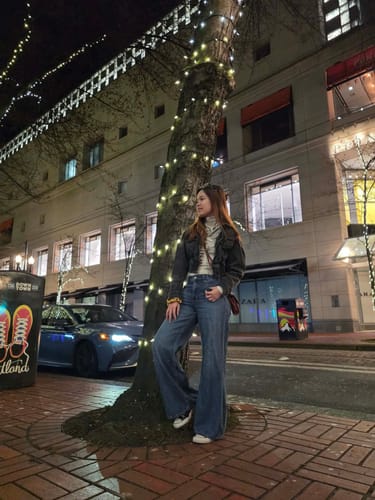 Reviewer wearing the Personsoul long sleeve tee layered under a dark jacket on a city street at night.