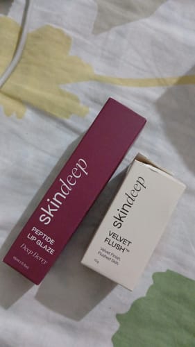 Customer's Lip Glaze+Velvet Flush Duo shown in their magenta and white product packaging.