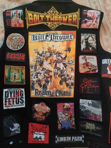 Customer's black vest covered in patches, showing the items from their safely delivered order.