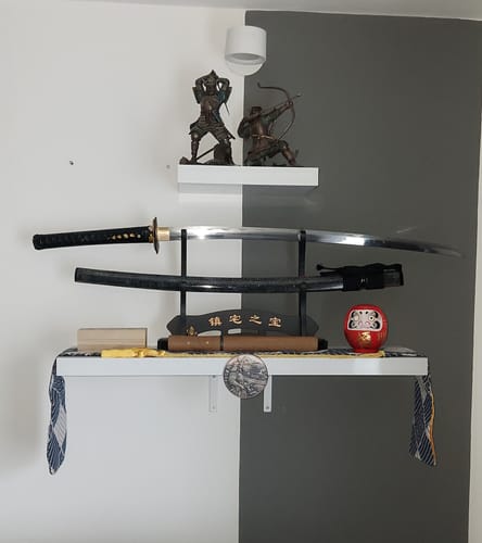Customer's Kokuryū Katana Sword on a wall display, showing the polished blade separate from its black scabbard.