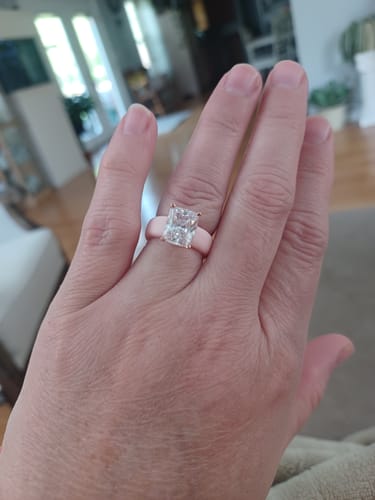 Customer's hand wearing the GlowStone Silicone Ring with a large emerald-cut stone.