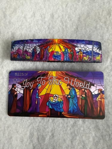 Customer's Joy To The World Bracelet and its collector's card, both featuring a colorful stained-glass nativity scene.