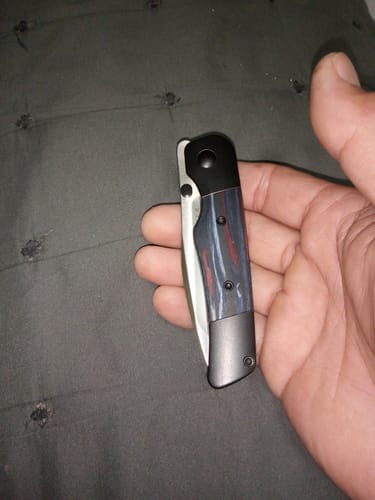 Customer holding the closed Kizer Coywolf Folding Knife, showing its compact size in hand.