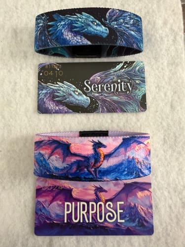 Customer's 'Serenity' and 'Purpose' Dragon Pack bracelets displayed with their matching illustrated cards on a white surface.